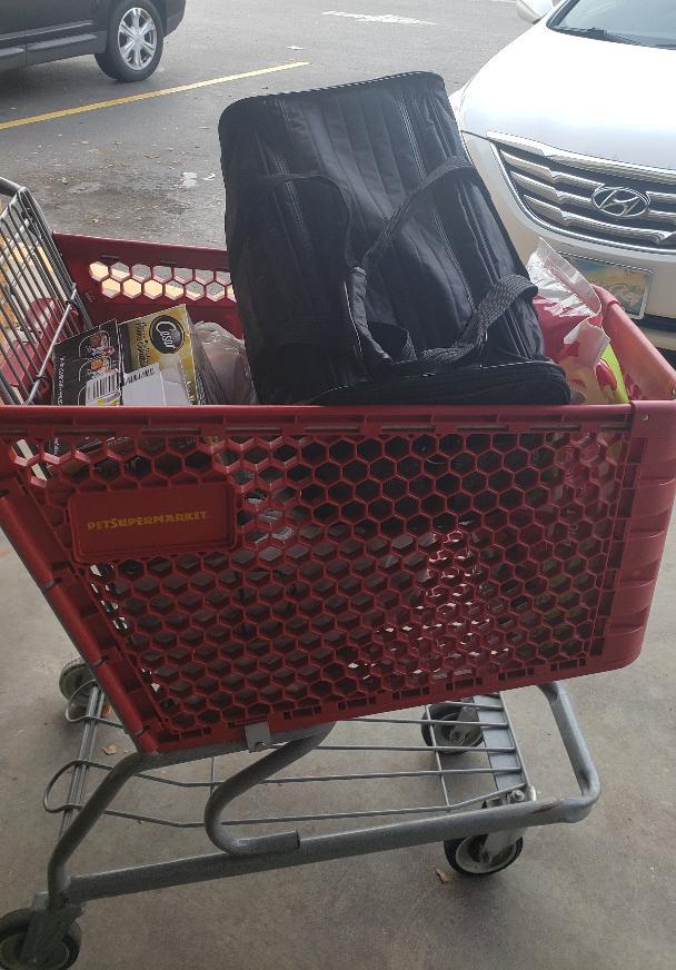 A shopping cart full of donations from Pet Supermarket.