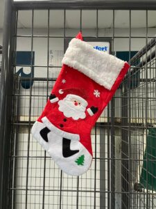 A stocking hanging on the kennel.