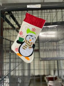 A stocking  hanging on the kennel.