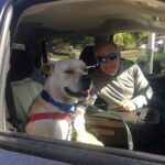 Lorenzo sitting in the passenger seat of the car with Dale in the driver's seat. Ready to go!