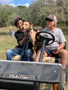 Bernie in the golf cart with Larry and Kris.