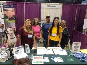 Satchel's volunteers - Jill, Maria, Doug, Michal Anne (staff) and Jacky behind the Satchel's table at the event.