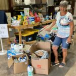 START Volunteer dropping off first load of donations. Many donations littering the floor.off 