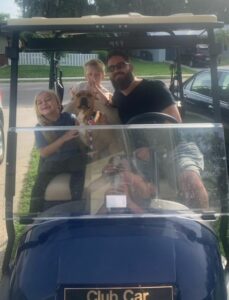 Bailey with her family in the golf cart.