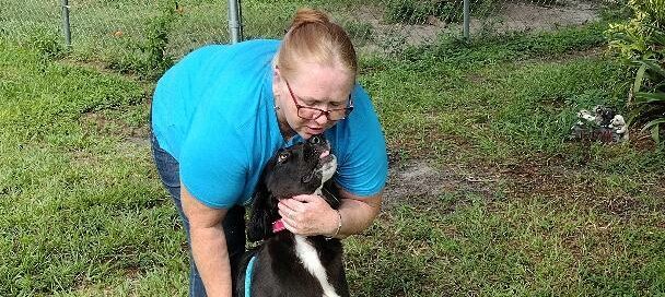 CK sitting with her new mom standing behind holding her in the yard at Satchel's