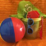 Pail with pool party supplies for each kennel when sponsored - beach ball, sunglasses, toy, bandana