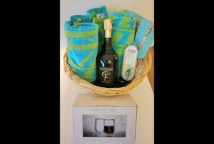 Picture of the basket showing a bottle of wine and beach towels.