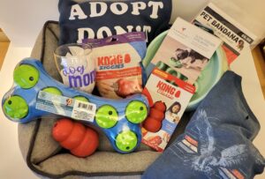 Picture of dog items in a basket - balls, Kong, bowl.