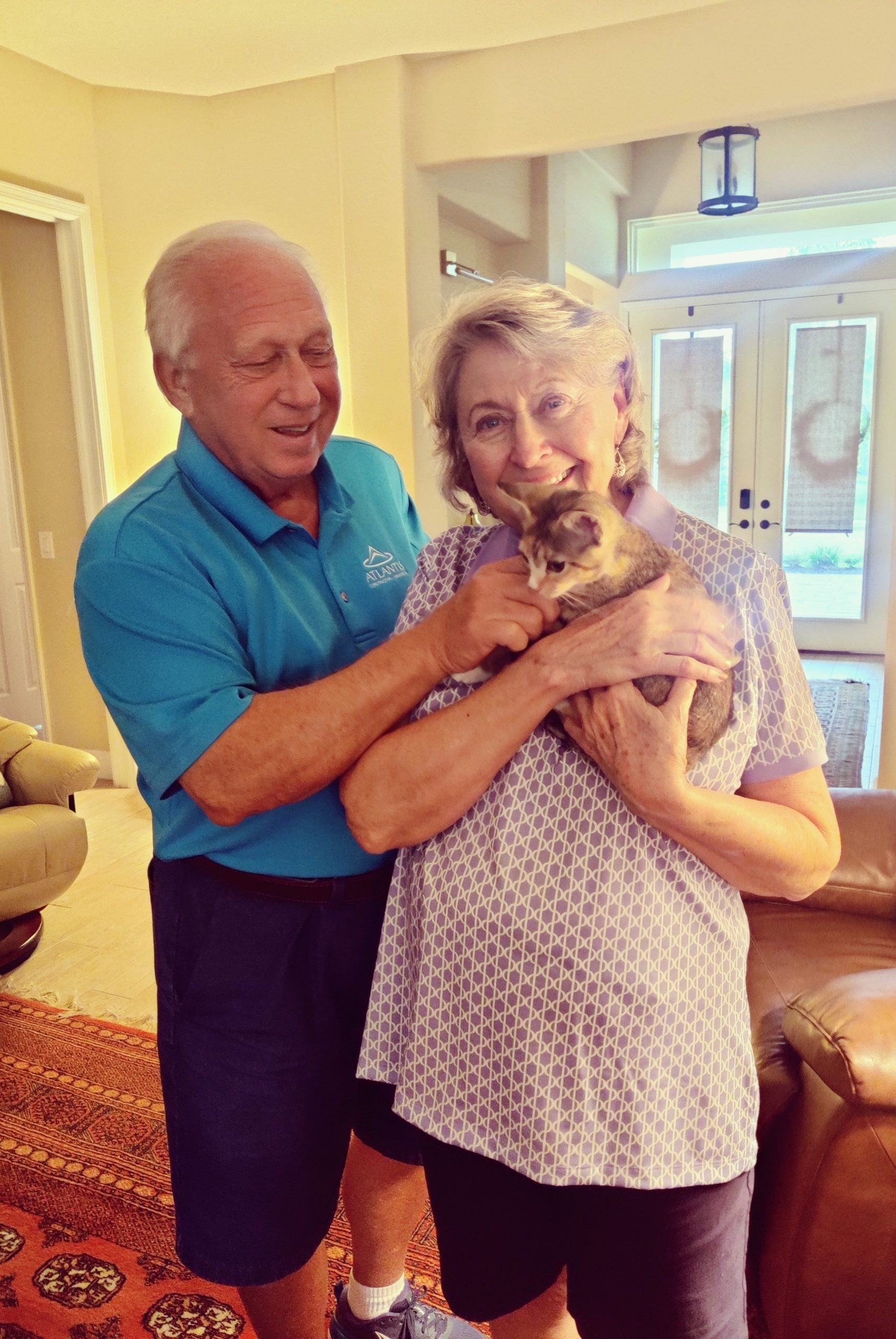 Maisy is in the arms of her new mom, dad by their side.