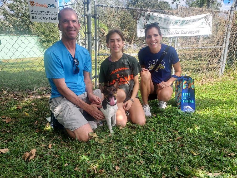 Pedro sitting on the grass on Satchel's with his new family.