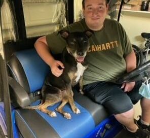 Stellar in a golf cart with dad.