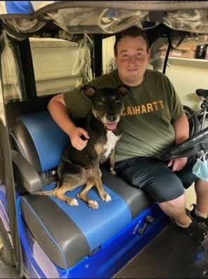 Stellar in a golf cart with dad.