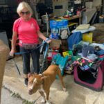 Cowboy and Kathy standing in front of the donations as they were unloaed at Satchel's.