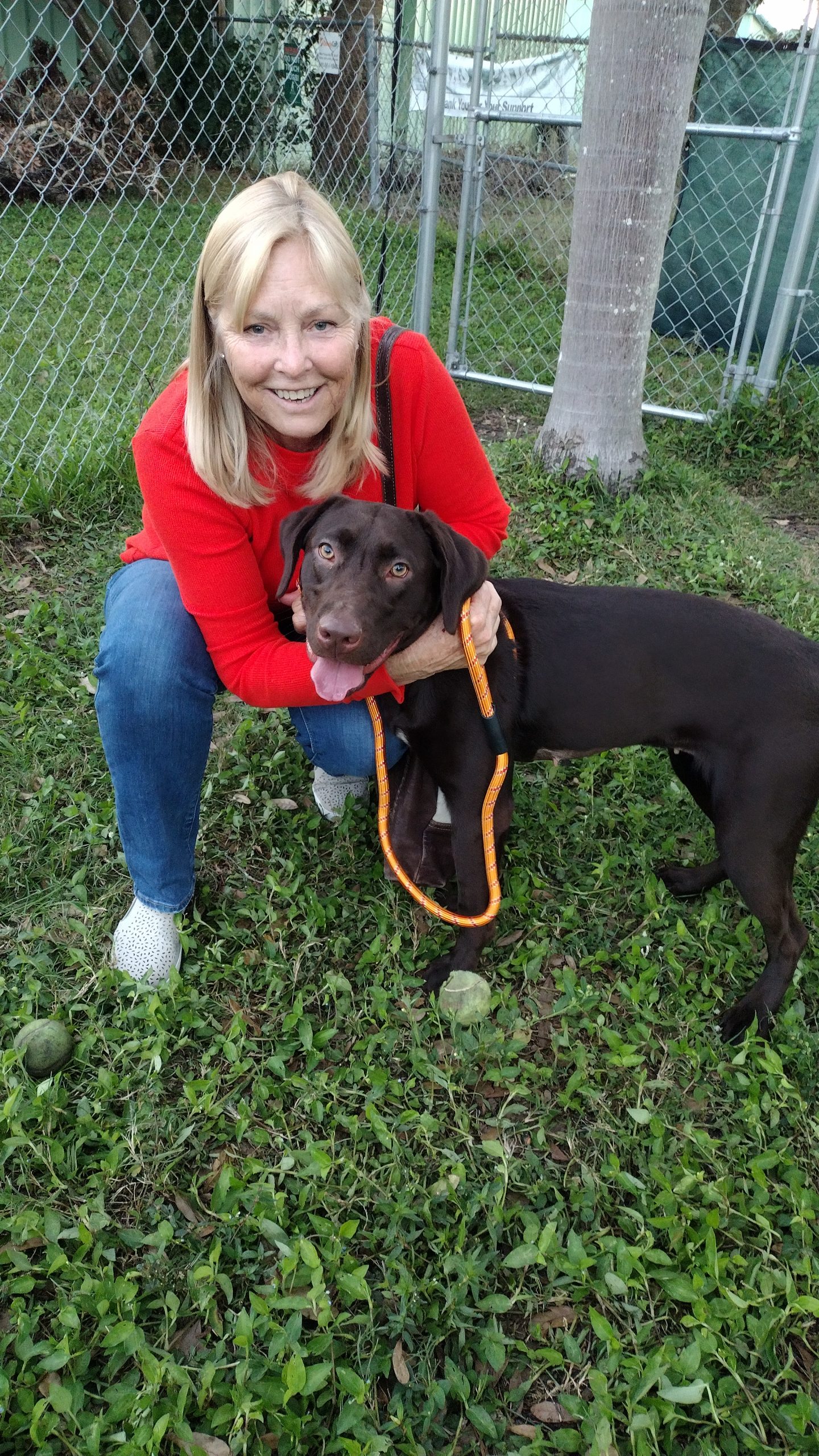 Willow standing beside her new mom, mom hugging her.