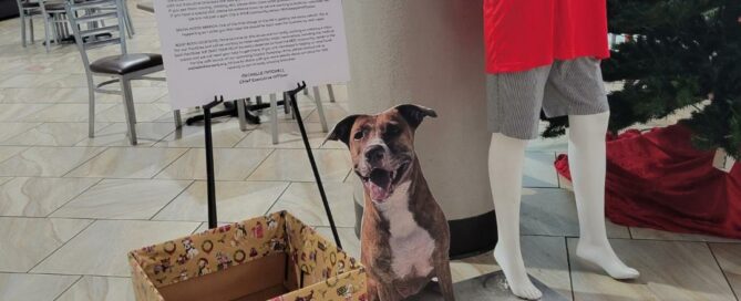 Holiday donation with dog cutout beside in the lobby at CORESRQ, Euclid branch.