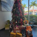 Donations in the holiday donation box and around the tree at Sunset Cadillac in Sarasota.
