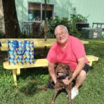 Cappy and his new dad sitting in the yard at Satchel's.