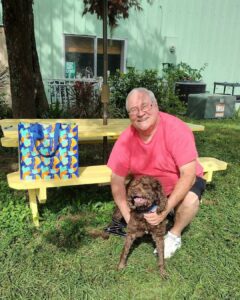 Cappy and his new dad sitting in the yard at Satchel's.