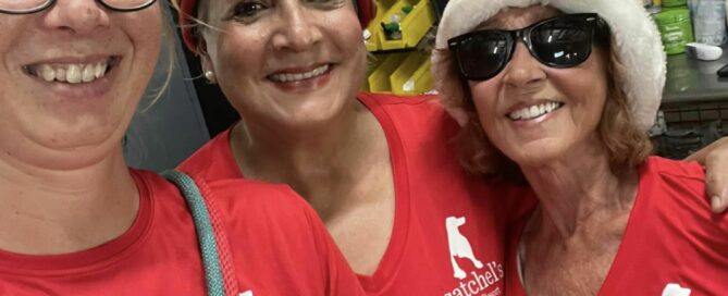 Lacie, Amelia and Pam our decorators in their red shirts ready to hang stockings.