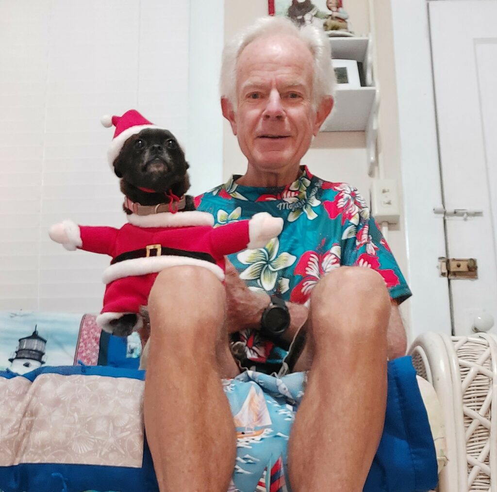 Delhi, dressed in a Santa suit, sitting on dad's lap.