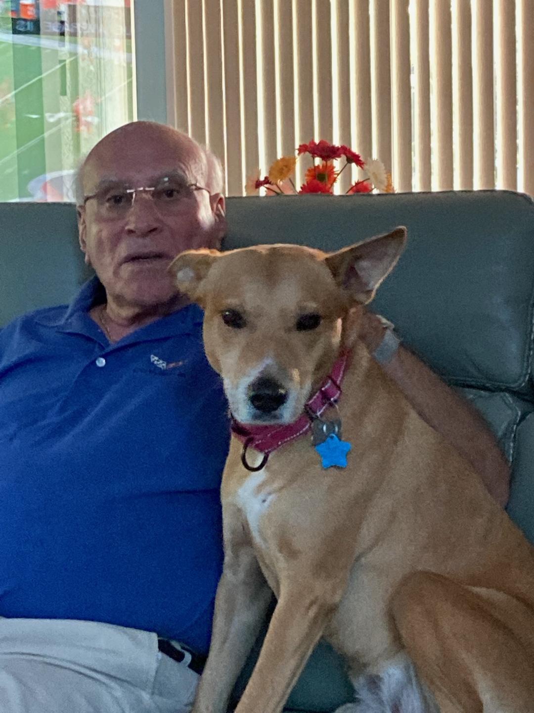 Meribel sitting on the couch with dad.