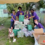The group of Ringling students, Page and ZigZag surrounding the gifts!