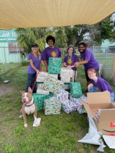 The group of Ringling students, Page and ZigZag surrounding the gifts!