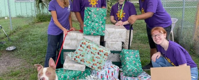 The group of Ringling students, Page and ZigZag surrounding the gifts!