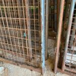 One of the rusty old kennels being removed.