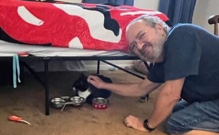 Lucie under the bed. Dad petting.