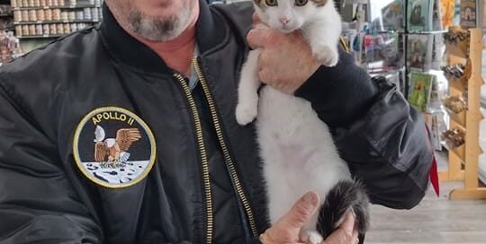 Luigi in the arms of his new dad at Pet Supermarket.