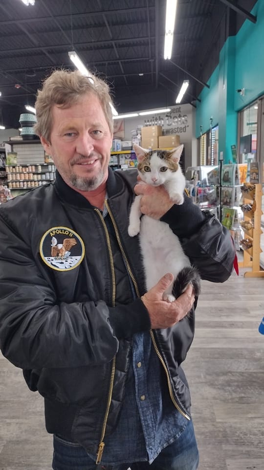 Luigi in the arms of his new dad at Pet Supermarket.