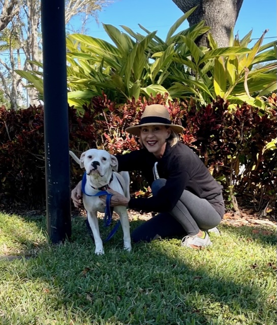 Millie with her new mom outside their home.