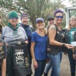 Members of the Skull Dogs presenting a check donation to Satchel's President, Jill.