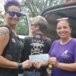 Members of the Skull Dogs presenting a check donation to Satchel's President, Jill.