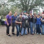 Members of the Skull Dogs standing beside the van of donations. Motorcycles behind.