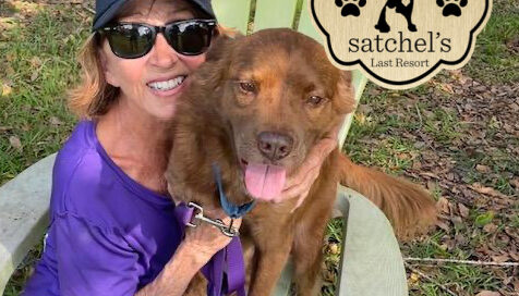 Winston and Pam sitting on a lawn chair at Satchel's. Both all smiles.