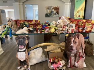 Table of donations with stand ups of Allman and Cowboy sitting in front.