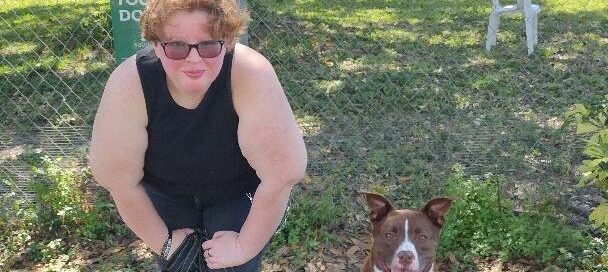 Tucker sitting nicely beside his new mom outside Satchel's.