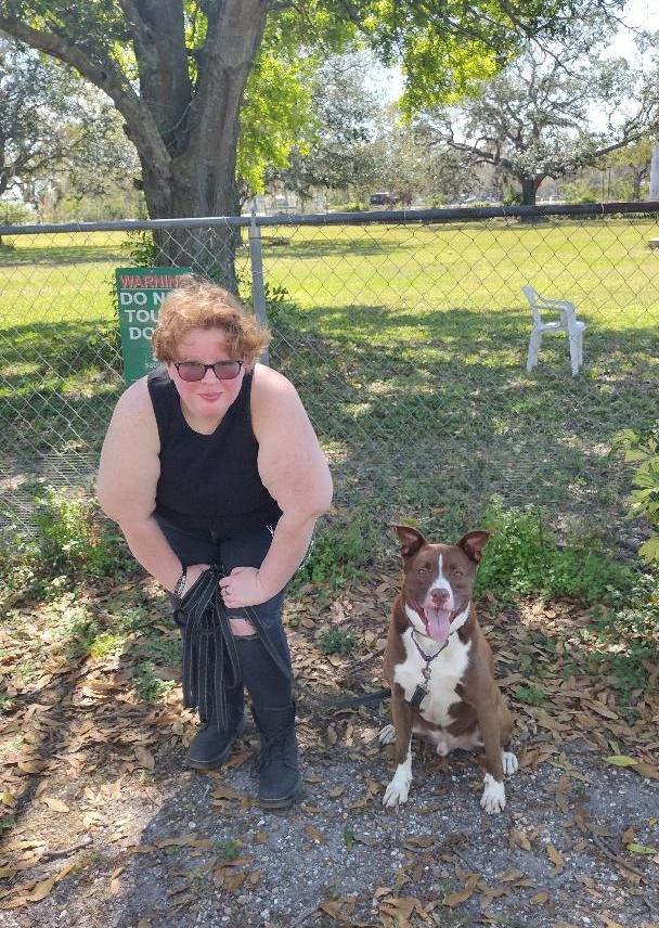 Tucker sitting nicely beside his new mom outside Satchel's.