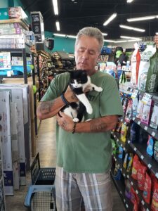 Ralphie in the arms of his new dad at Pet Superemarket.