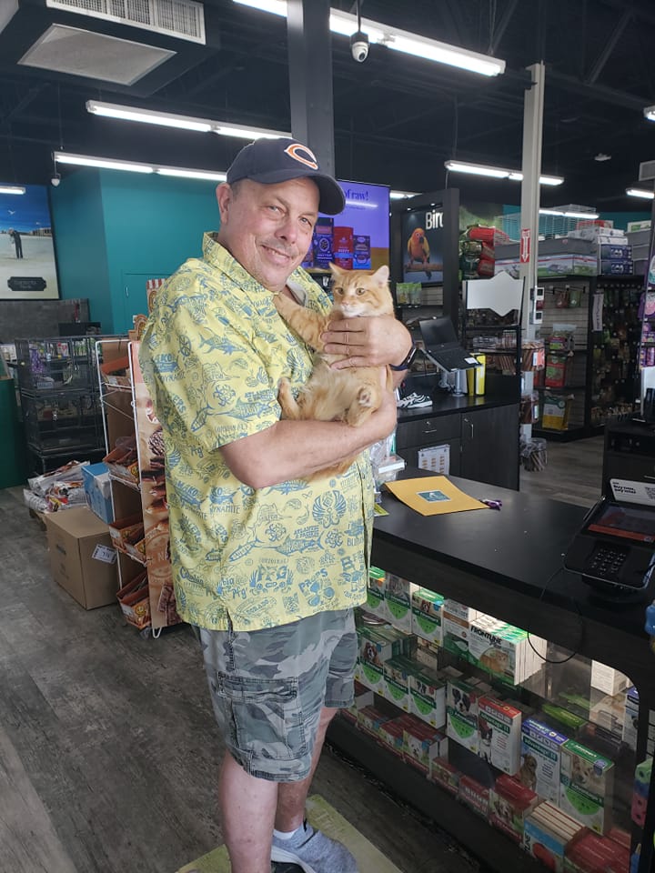 Mufasa in the arms of his new dad at Pet Supermarket.
