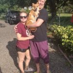 Sparky in the arms of his new dad. Mom by their side.