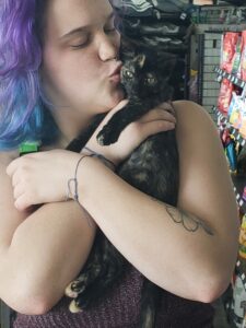 Dinah in the arms of her new mom, getting a kiss and cuddle.