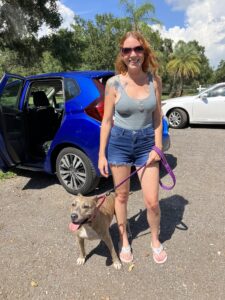 Scarlett standing outside Satchel's with her new mom.