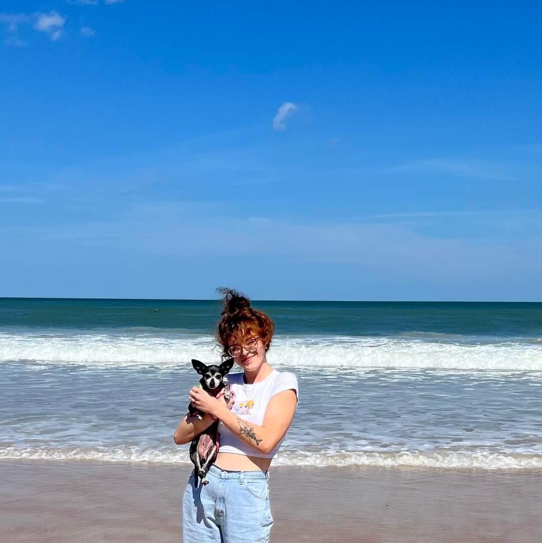 Darla in her mom's arms on the beach.